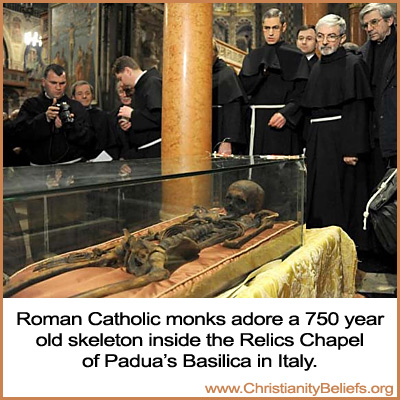 Roman Catholic monks adore a 750 year old skeleton inside the Relics Chapel of Padua's Basilica in Italy