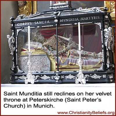 Saint Mudita reclines on her velvet throne at Peterskirche, Stain Peter's Church, in Munich