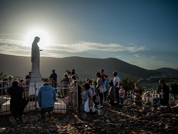 pilgrims visiting Virgin Mary statue at Medjugorje in Bosnia and Herzegovina