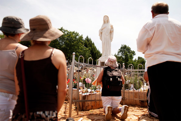Catholics pray at the site where the Virgin Mary reportedly appeared as an apparition in Medjugorje